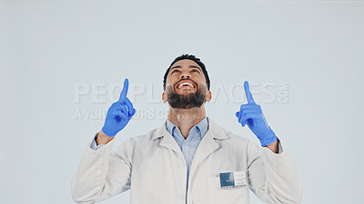 Buy stock photo Doctor, studio and pointing up with happy man for advertising or marketing on a white background. Male person, healthcare worker or smile with option, selection or choice for announcement on space