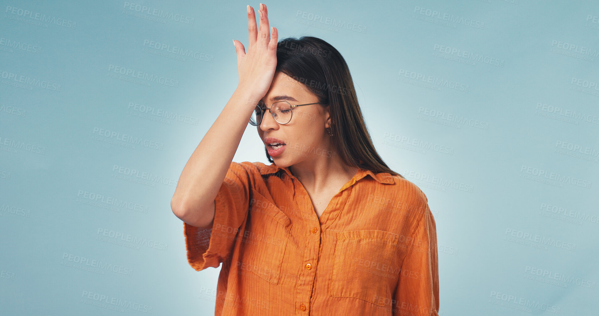 Buy stock photo Woman, stress and studio with mistake for brain fog, regret or bad news on a blue background. Upset, female person or forget with disappointment for schedule delay, poor reminder or memory loss