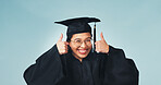 Portrait, student and graduation in studio with thumbs up, celebration and thank you for success. Smile, woman or graduate with hand gesture, like university and education feedback on blue background