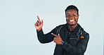 Hiking, announcement and man with smile, pointing and travel advice for adventure and recommendation. Blue background, space and black person with directions, portrait and backpacking presentation