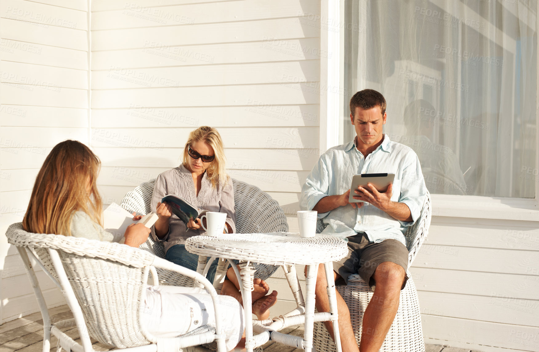 Buy stock photo Relax, child and parents with reading on porch for literacy interest, sun basking and knowledge. Bonding, family and peaceful at home with ebook chapter, magazine and fantasy fiction on weekend hobby