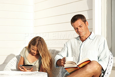 Buy stock photo Man, relax and reading book on patio with child, bonding and literature novel for weekend break. Father, coffee and daughter browsing with tablet, fiction story and information for knowledge at house