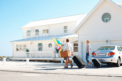 Buy stock photo Back, travel and family outdoor with suitcase, road trip and adventure at holiday house. Parents, walk and daughter at getaway accommodation with luggage, vacation break and parked car at destination