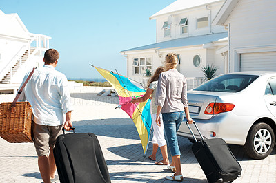 Buy stock photo Back, travel and family at beach house with luggage, road trip and adventure at holiday retreat. Ocean, parents and child at getaway resort with suitcase, vacation break and parked car at destination