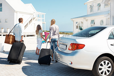 Buy stock photo Child, travel and parents at beach house with suitcase, road trip and adventure at holiday retreat. Back, family and ocean at getaway resort with luggage, vacation break and parked car at destination