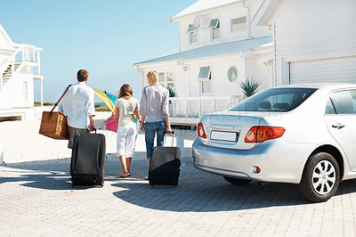 Buy stock photo Back, travel and family at beach house with suitcase, road trip and adventure at holiday retreat. Ocean, parents and child at getaway resort with luggage, vacation break and parked car at destination
