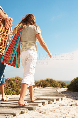 Buy stock photo Back, travel and child at beach for holiday, adventure and morning journey on boardwalk. Blue sky, kid and walking on pathway with family, tropical picnic and weekend break for vacation at seaside