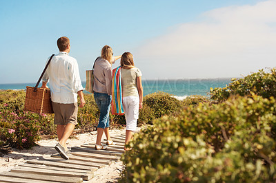 Buy stock photo View, boardwalk and love with family at beach for summer vacation, bonding and tropical adventure. Holiday, care and picnic basket with parents and child outdoor for support, back and sightseeing