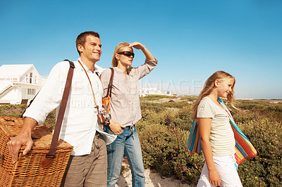 Buy stock photo Happy, travel and love with family in nature for summer vacation, bonding and tropical adventure. Holiday getaway, care and picnic basket with parents and child outdoor for support and sightseeing