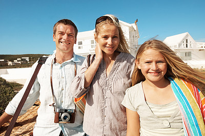 Buy stock photo Portrait, parents and child for vacation at coast with picnic basket, bonding and weekend break. Happy, relationship and people with kid outdoor for summer holiday, support or ready for family outing