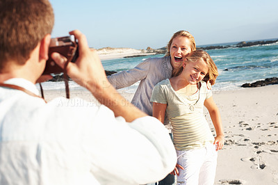 Buy stock photo Excited, photography and family at beach with camera, picture and capture moment on holiday. Happy, mother and daughter at sea with photoshoot, travel blog and bonding together on tropical vacation