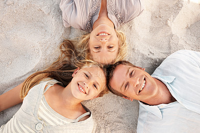 Buy stock photo Portrait, child and parents with smile at beach for weekend break, summer vacation and bonding. Above, relax and people with happy girl on sand for holiday connection, family outing and relationship