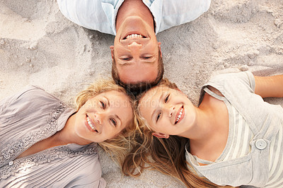 Buy stock photo Above, travel and sand with family at beach for love, adventure and bonding together on holiday. Portrait, parents and rest at sea with daughter, connection and happiness outdoor on tropical vacation
