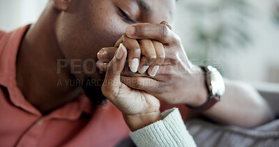 Buy stock photo Couple, kiss and holding hands with man, lounge and connection with partner on weekend and affection. People, together and bonding with spouse, love and commitment for relationship in house.