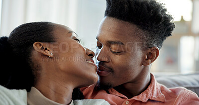 Buy stock photo Couple, smile and love in living room with connection, loyalty and bonding together for relationship. Happy, black people and relax in house with marriage commitment, affection and care for partner.