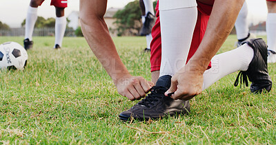 Buy stock photo Hands, grass and soccer player tying laces for match, training or exercise outdoor on field. Sports, man and athlete with togs for preparing for football game, workout or practice for championship.