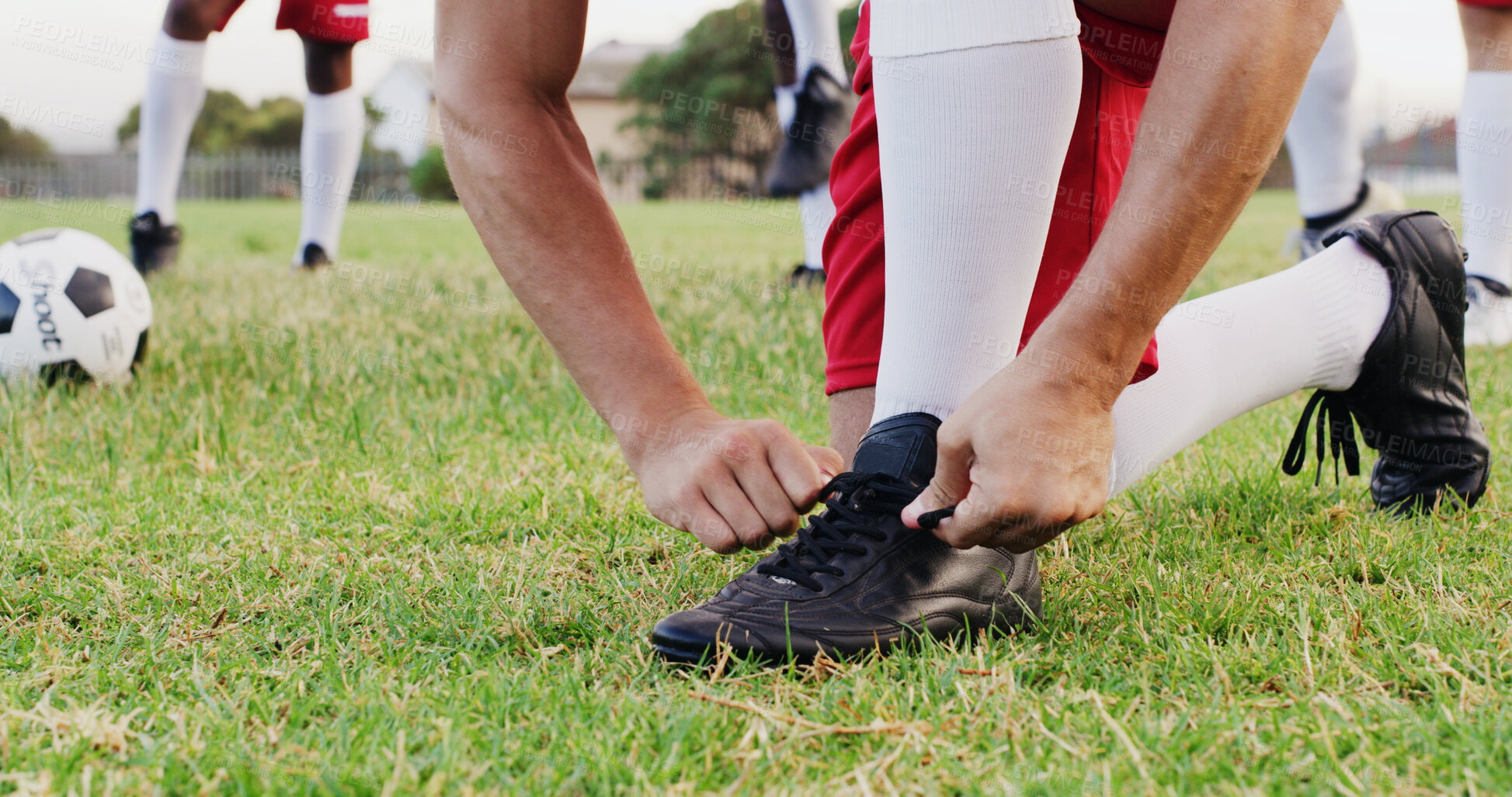 Buy stock photo Hands, grass and soccer player tying laces for match, training or exercise outdoor on field. Sports, man and athlete with togs for preparing for football game, workout or practice for championship.