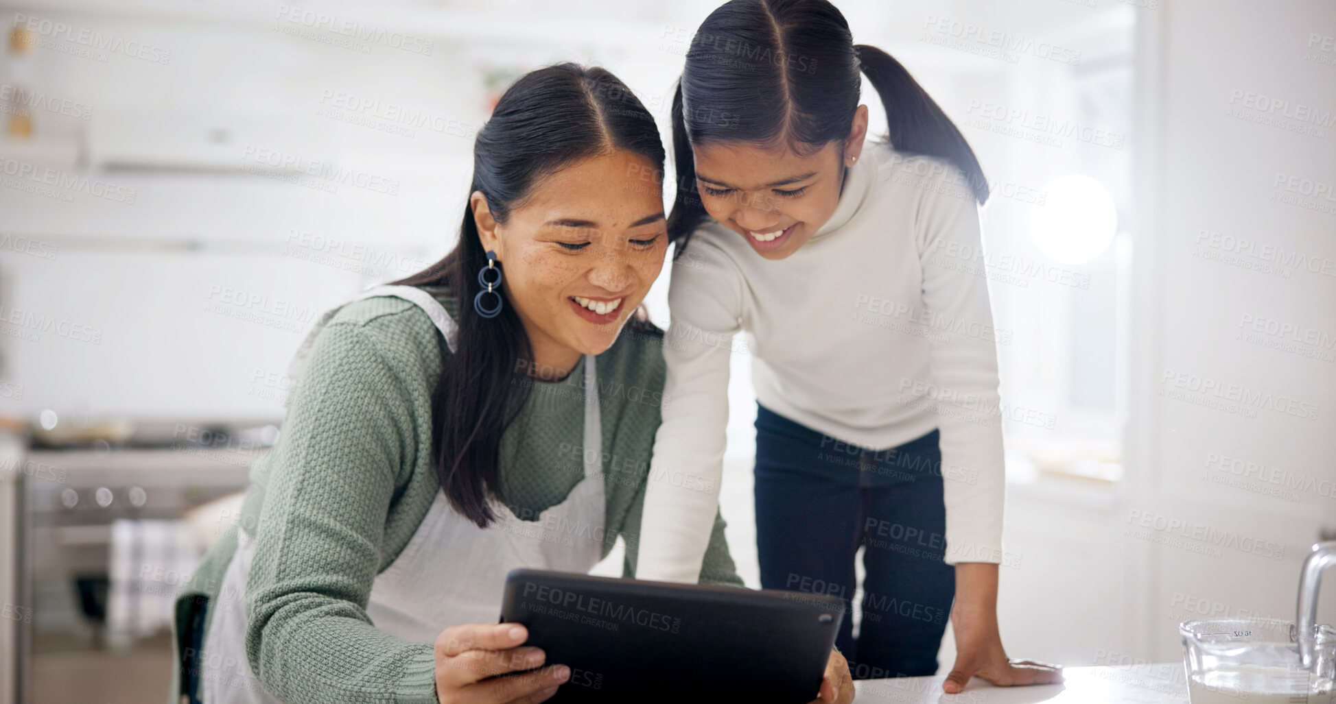 Buy stock photo Daughter, happy and mother with tablet in kitchen of home for child development or learning. App, love or smile with girl and single parent woman in apartment for bonding or online streaming