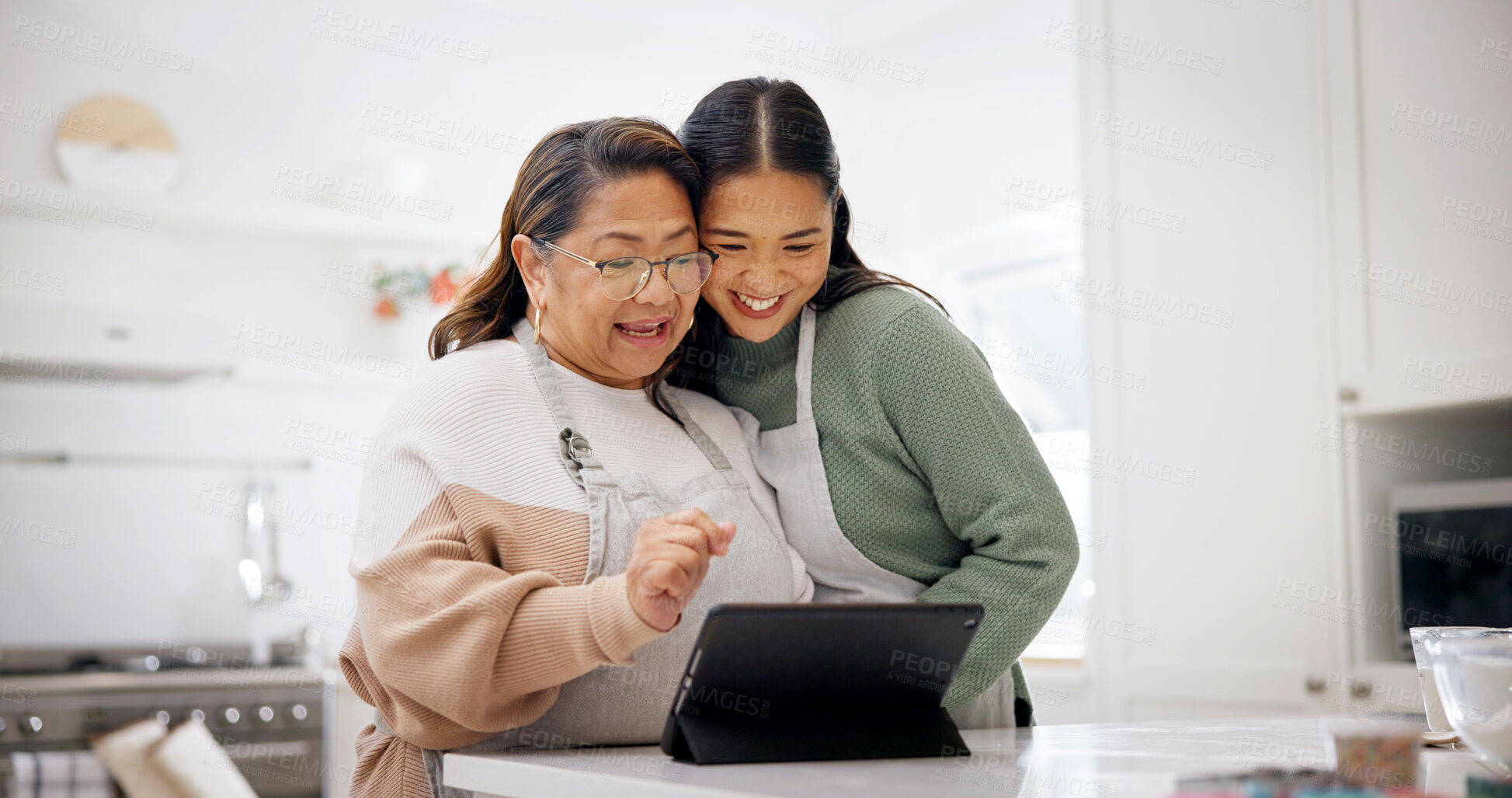 Buy stock photo Baking, old woman and daughter with tablet in kitchen, laughing and searching for recipe on website. Happy people, online and meal prep with senior mom, family and skill development with tips in home