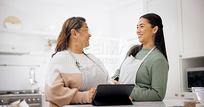 Buy stock photo Baking, old woman and daughter with tablet in home, laughing or searching for recipe on social media. Happy people, online and meal prep with senior mom, talk and learning culinary skills in kitchen