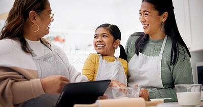 Buy stock photo Baking, family and child with tablet in kitchen, laughing or research for dessert preparation on web. Happy people, home and meal prep with kid, online and senior woman with tech for culinary skills