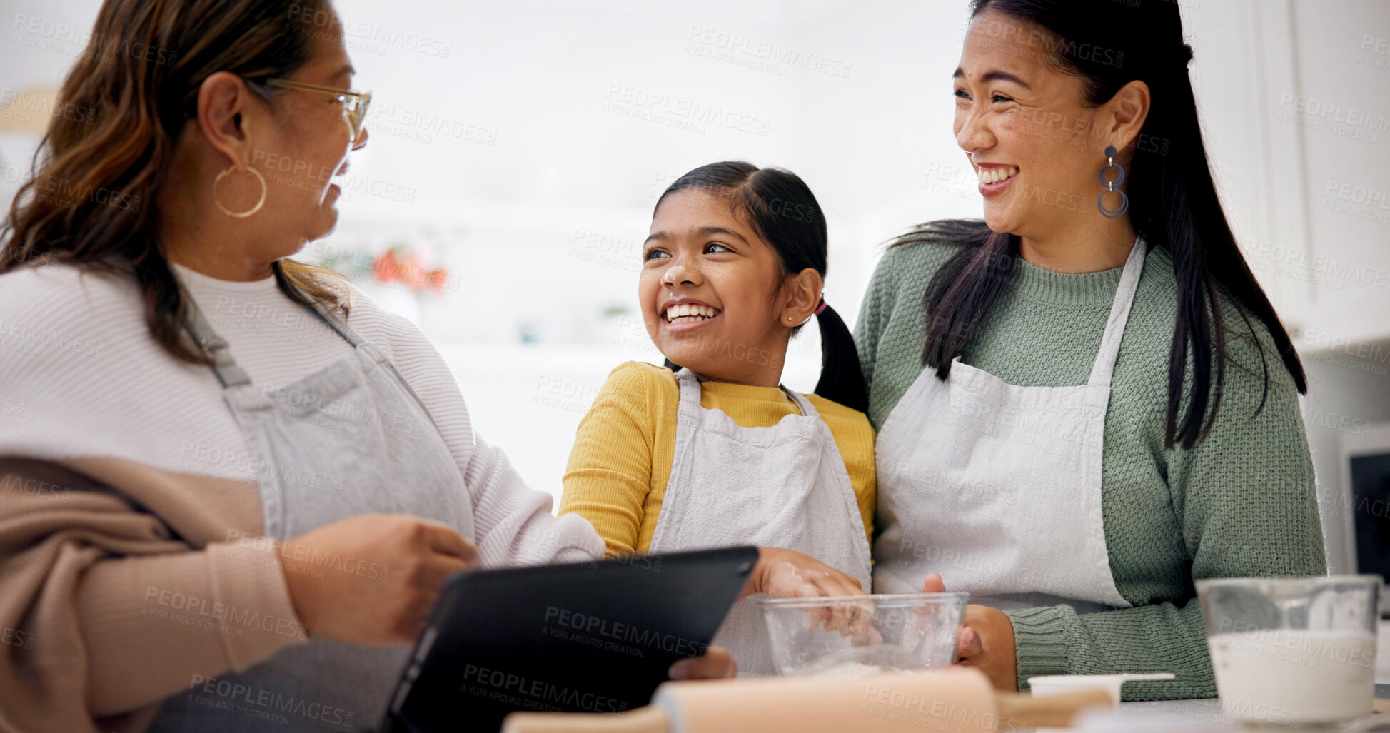 Buy stock photo Baking, family and child with tablet in kitchen, laughing or research for dessert preparation on web. Happy people, home and meal prep with kid, online and senior woman with tech for culinary skills