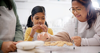 Buy stock photo Cookies, eating and child with grandma and mother in home for baking results, snack or sweet treat. Family, bonding and girl kid with mom and senior woman for biscuits in kitchen at apartment.