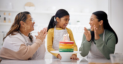 Buy stock photo Child, family and clapping with birthday cake in home after baking, laugh and generations sing. Mother, grandmother and girl with applause at party, rainbow dessert or excited to celebrate in kitchen