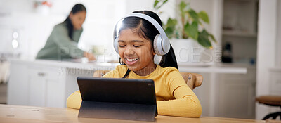 Buy stock photo Headphones, reading and child with tablet at table, online education and watch live stream of class. Smile, elearning app and girl with tech for academic development, school project and family home