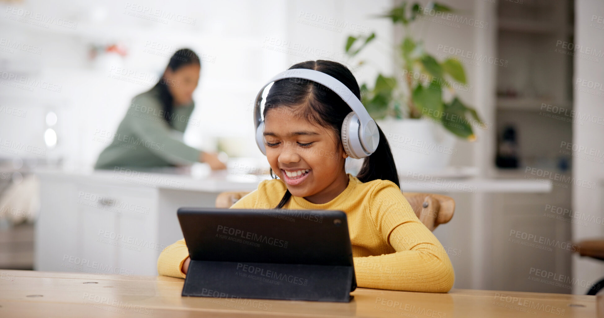 Buy stock photo Headphones, smile and child with tablet at table, online education and watch live stream of class. Reading, elearning app and girl with tech for academic development, research project and family home