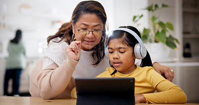 Buy stock photo Tablet, headphones and grandmother with child for elearning, online lesson or studying in home. Digital technology, help and senior woman with girl kid for virtual class with development in house.
