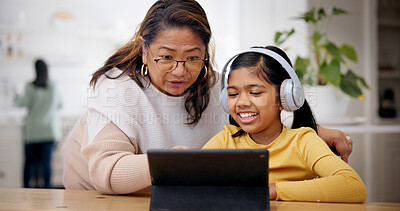 Buy stock photo Tablet, headphones and grandma with child for elearning, online lesson or studying in home. Digital technology, help and senior woman with girl kid for virtual class with development in house.