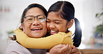 Love, grandmother and child with hug in home for support, affection and security for weekend bonding. Portrait, senior woman and girl with embrace for connection, relationship development and smile