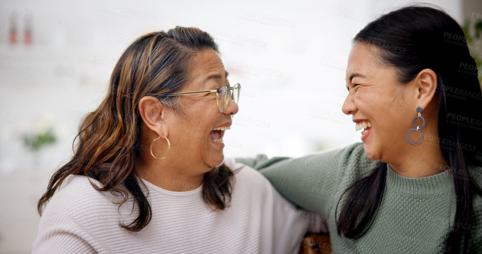 Buy stock photo Happy, hug and woman with senior mother on sofa in home for bonding, connection or family. Laugh, retirement and Asian person embracing elderly mom for joke, safety and love in living room at house.