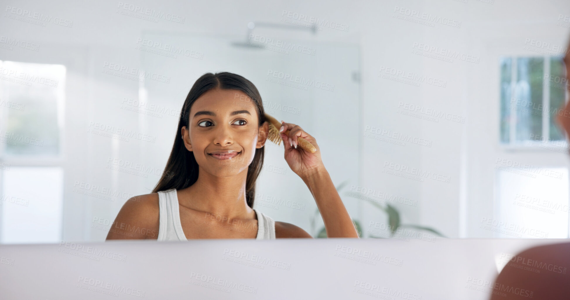 Buy stock photo Woman, happy and mirror in house with hairbrush for morning routine, grooming and hair care in bathroom. Bamboo brush, smile and reflection with person in home for beauty, selfcare and getting ready