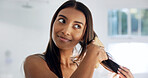 Woman, smile and brushing hair for haircare in home, morning routine and grooming in bathroom. Bamboo brush, hairstyle and Indian female person in house for beauty, self care and getting ready