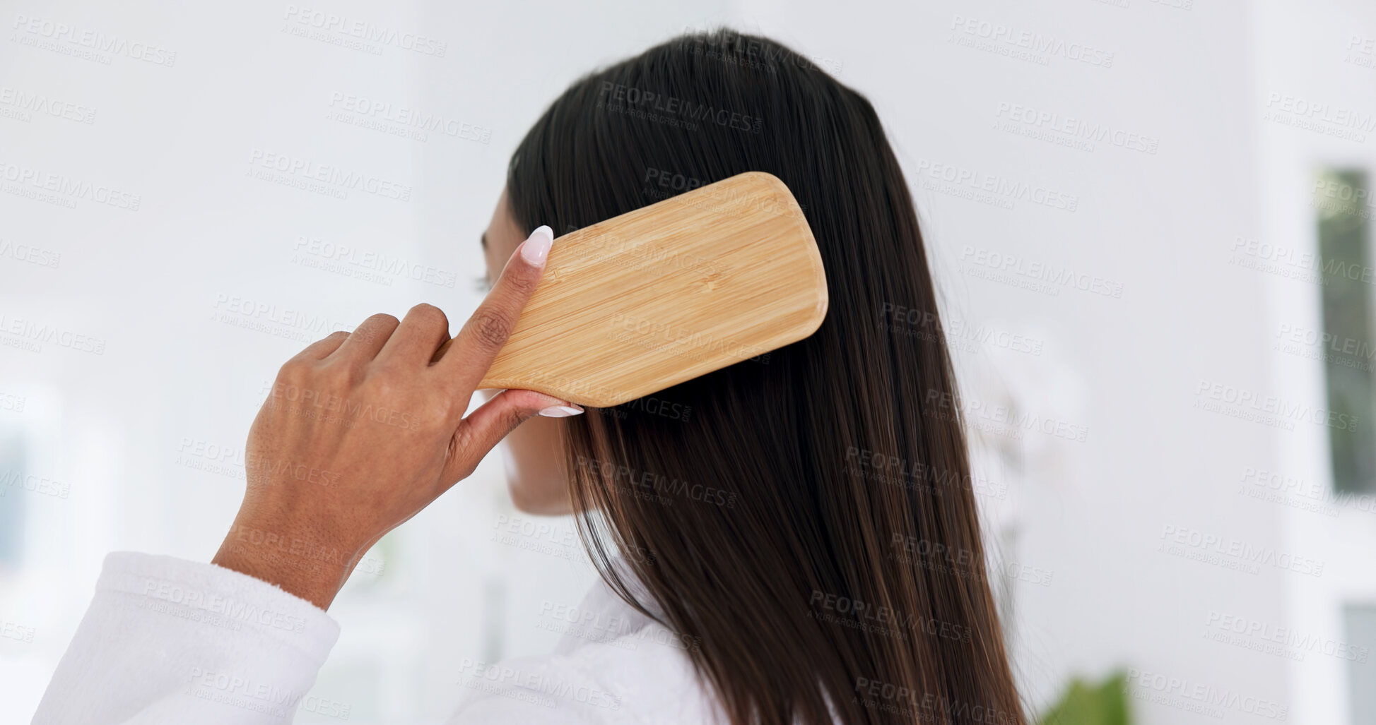 Buy stock photo Woman, brushing hair and haircare in home with back, morning routine and grooming in bathroom. Bamboo brush, female person and self care at house for beauty, texture and getting ready with tools
