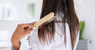 Buy stock photo Hand, brushing hair and haircare in home with back, morning routine and grooming in bathroom. Bamboo brush, female person and self care in house for beauty, texture and getting ready with tools