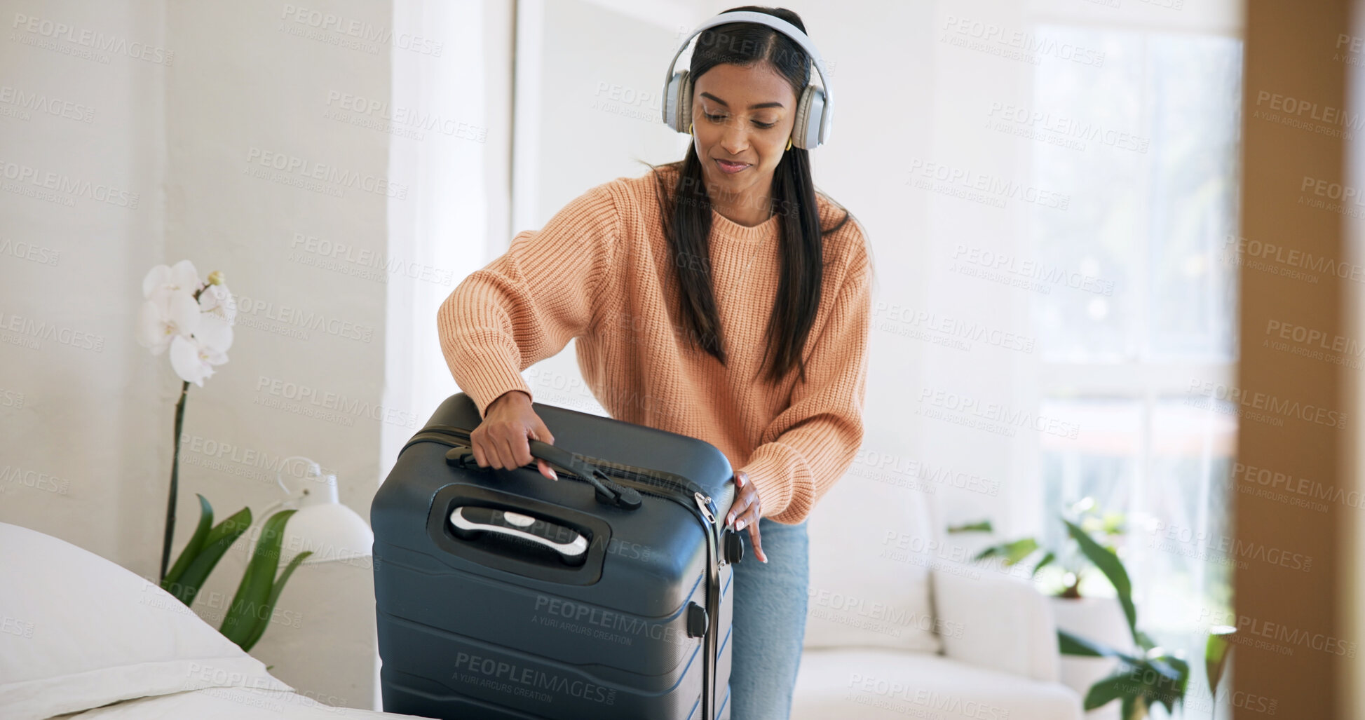 Buy stock photo Smile, suitcase or woman with headphones in hotel room, holiday trip or music for travel preparation. Vacation luggage, streaming playlist and person with completed packing, leaving and audio tech