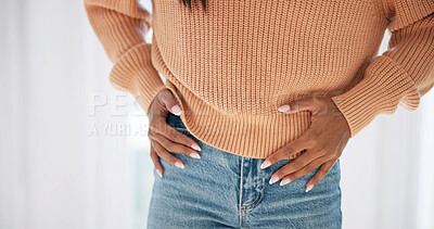 Buy stock photo Hands, pain and woman in home with stomach, discomfort and symptoms of menstruation. Sore, female person and cramps at house with abdomen ache, constipation and inflammation for chronic endometriosis