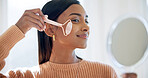Woman, mirror and face roller with skincare, lymphatic drainage or blood circulation benefits in home. Happy, female person and beauty tools in house with dermatology, wellness or inflammation relief
