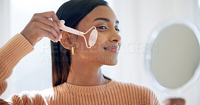 Buy stock photo Woman, mirror and face roller with skincare, lymphatic drainage or blood circulation benefits in home. Happy, female person and beauty tools in house with dermatology, wellness or inflammation relief