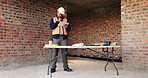 Construction, tablet and black man in building for online report, site inspection and compliance review. Architecture, engineer and person on tech for renovation, remodeling and infrastructure design