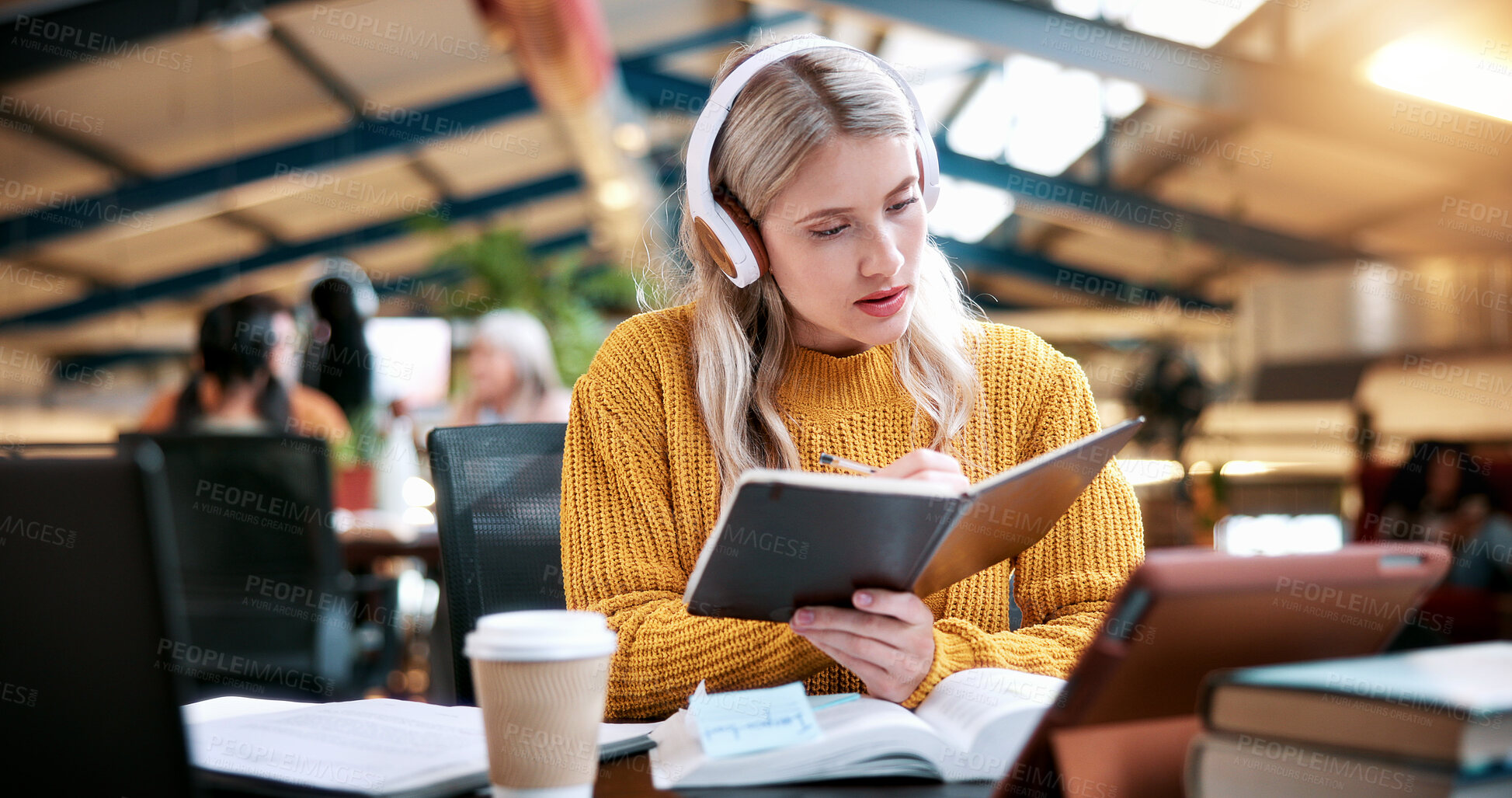 Buy stock photo Student, reading and book with headphones in library for higher education, learning or studying. Woman, academic learner or writing with notebook or research for knowledge, assignment essay or thesis