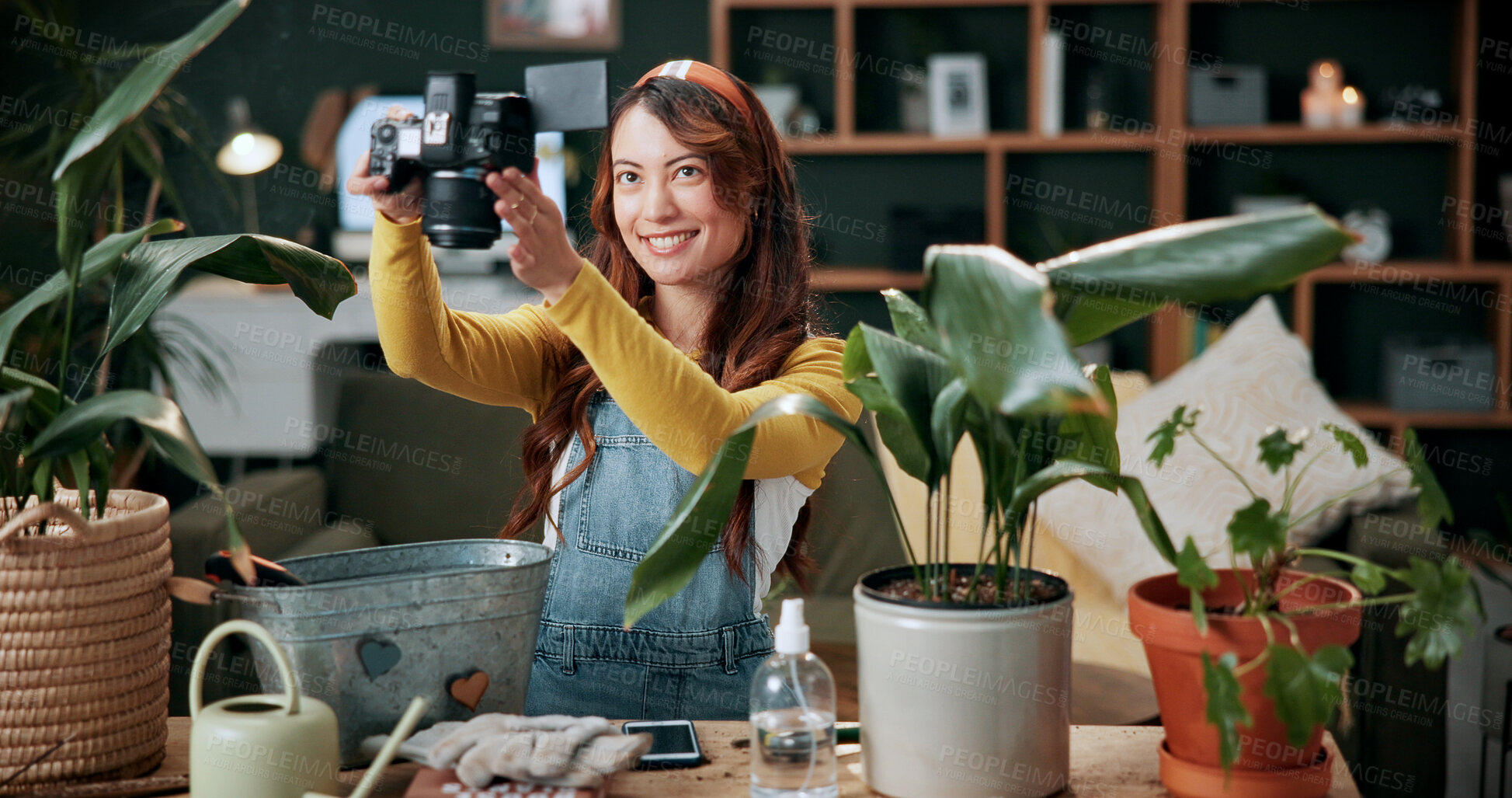 Buy stock photo Remote work, camera or woman in home with plants, greenery review or picture in gardening blog. Smile, freelance or journalist with houseplant, horticulture or growth photography in botanical article