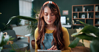 Buy stock photo Reading, botany and woman with tablet in home for potted plant, blog and growth for horticulture. Feng shui, botanist and gardener with tech for eco friendly, decoration and organic living room