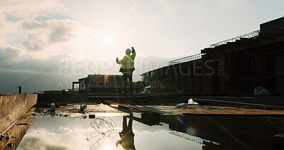 Buy stock photo Fist pump, celebration and man at construction site for architecture, back and successful inspection. Outdoor, civil engineer and person with achievement on roof, space and property development