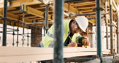Buy stock photo Planning, man and civil engineer by infrastructure on site for building, repairs or maintenance. Wood, professional and male construction worker with timber measurement for home renovation project.