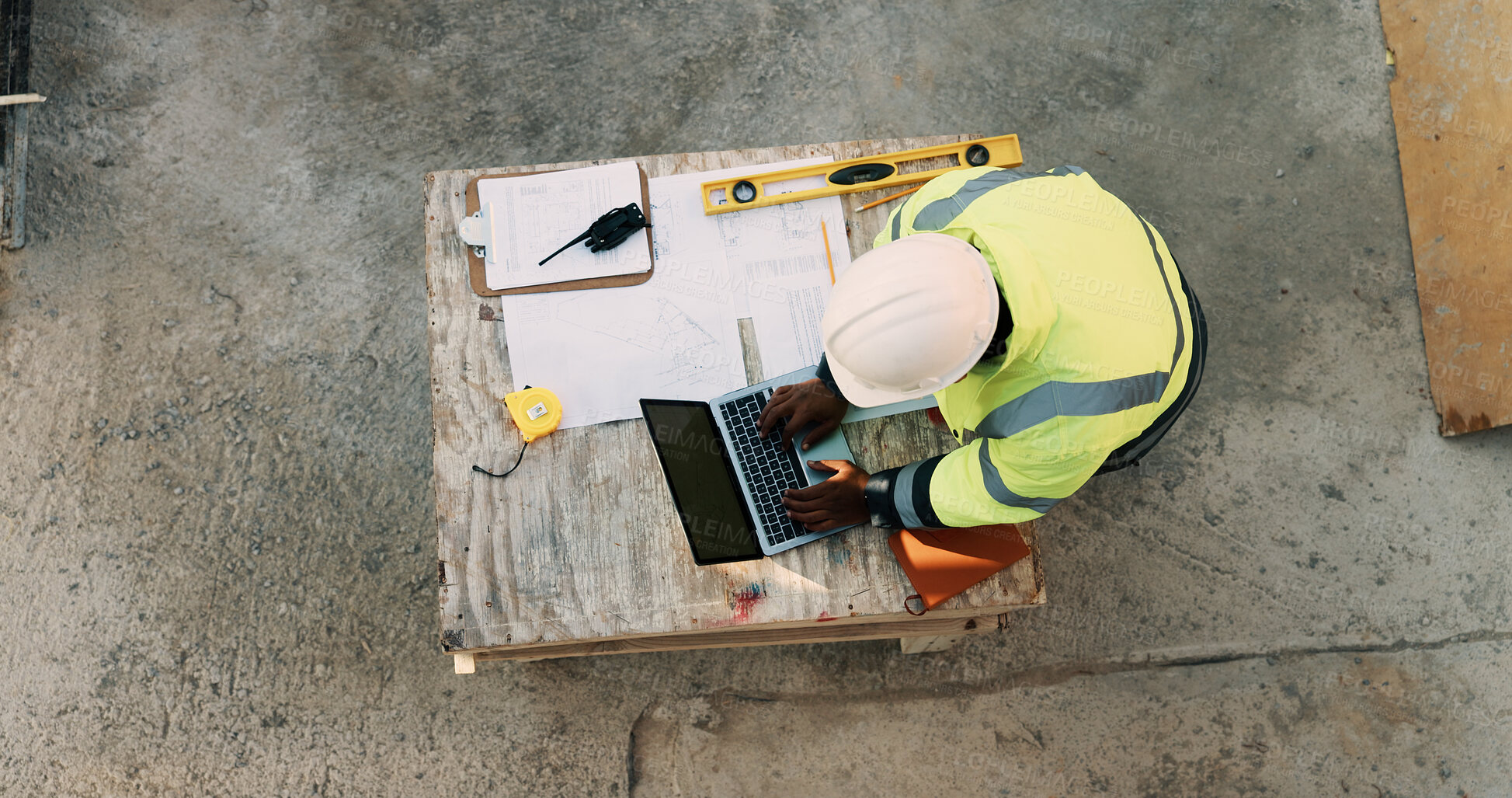 Buy stock photo Documents, laptop and above of man on construction site for planning, building permit and compliance. Architecture, engineer and person on computer for renovation, online blueprint and infrastructure