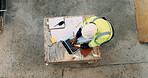 Typing, laptop and above of man on construction site for planning, building permit and compliance. Architecture, documents and person on computer for renovation, online blueprint and infrastructure